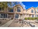 A charming two-story townhome with mature landscaping and a walkway at 13842 S 40Th St # 1004, Phoenix, AZ 85044