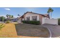 Side view of the house with mature landscaping and a partial view of the backyard at 13872 N 89Th St, Scottsdale, AZ 85260