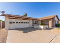 Front view of the house, showcasing the garage and landscaping at 13872 N 89Th St, Scottsdale, AZ 85260