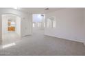 High ceiling living room with an open floor plan and neutral decor at 16370 W Adams St, Goodyear, AZ 85338