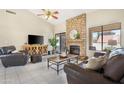 Spacious living room with fireplace and leather furniture at 17014 E De Anza Dr, Fountain Hills, AZ 85268