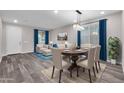 Dining area with wood table, light-colored chairs, and gray floors at 1715 W Satinwood Dr, Phoenix, AZ 85045