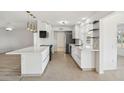 Modern white kitchen with an island and breakfast bar at 17635 N Buntline Dr, Sun City West, AZ 85375