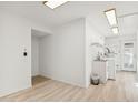 Bright laundry room with utility sink and cabinets at 17635 N Buntline Dr, Sun City West, AZ 85375