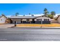 Charming single-story home with a well-maintained yard, covered parking and gray color scheme at 1839 E Indigo St, Mesa, AZ 85203