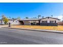 Charming single-story home with a well-maintained yard, covered parking and gray color scheme at 1839 E Indigo St, Mesa, AZ 85203