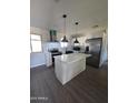 Modern kitchen with white cabinets, a large island, and stainless steel appliances at 1839 E Indigo St, Mesa, AZ 85203