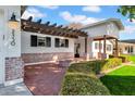 Inviting front porch with brick flooring and pergola at 2130 E San Juan Ave, Phoenix, AZ 85016