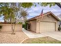 Charming home exterior with well-maintained landscaping, a two-car garage, and inviting curb appeal at 2131 W Ironwood Dr, Chandler, AZ 85224