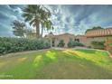 Landscaped front yard with mature trees and lush green grass at 2131 W Ironwood Dr, Chandler, AZ 85224