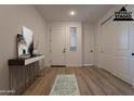 Bright and airy entryway with hardwood floors and a modern console table at 21411 W Meadowbrook Ave, Buckeye, AZ 85396