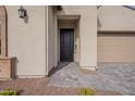 Front entry with a black door and a stone walkway at 21418 W Meadowbrook Ave, Buckeye, AZ 85396