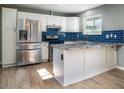 Modern kitchen featuring granite countertops and stainless steel appliances at 2215 E Des Moines Cir, Mesa, AZ 85213