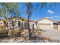 House exterior with a two-car garage and mature trees at 2410 W Aloe Vera Dr, Phoenix, AZ 85085