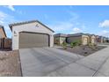 Two-car garage and driveway with desert landscaping at 2732 E Trail Blazer Dr, San Tan Valley, AZ 85140