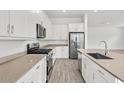 Modern kitchen with white cabinets, stainless steel appliances, and light countertops at 2929 E Birdsong Ave, San Tan Valley, AZ 85143