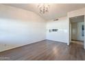 Living room with vaulted ceiling, wood-look floors, and neutral walls at 2929 E Broadway Rd # 13, Mesa, AZ 85204