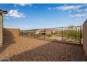 Spacious backyard with gravel and a metal fence, providing privacy at 31817 N 124Th Dr, Peoria, AZ 85383