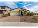 Single-story home with a beige exterior, brick driveway, and desert landscaping at 31817 N 124Th Dr, Peoria, AZ 85383