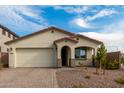 Charming single-story home with a beige exterior and a two-car garage at 31817 N 124Th Dr, Peoria, AZ 85383