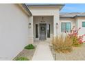 Modern front entry with gray door and walkway at 3588 W New Life Ln, Queen Creek, AZ 85144