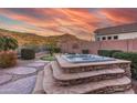 Spacious hot tub with stone surround and mountain backdrop at 4202 S Cordia Ct, Gold Canyon, AZ 85118