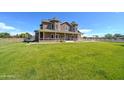 Charming multi-story brick house with a large green lawn and inviting front porch at 424 E Lehi Rd, Mesa, AZ 85203
