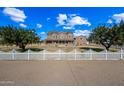 Two-story brick home with a white picket fence and a large front yard at 424 E Lehi Rd, Mesa, AZ 85203