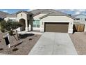 House exterior featuring a brown garage door and a landscaped front yard at 44478 W Palo Abeto Dr, Maricopa, AZ 85138