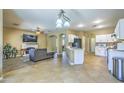 Open kitchen with white cabinets, modern appliances, and tile floors at 4711 E Silverwood Dr, Phoenix, AZ 85048