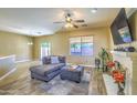 Living room with fireplace, sectional sofa, and tile floors at 4711 E Silverwood Dr, Phoenix, AZ 85048