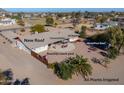 Aerial view of a home with a large backyard, covered patio, hot tub, and wood pizza oven at 52615 W Esch Trl, Maricopa, AZ 85139