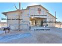 Fully enclosed 5-stall barn with turn-out alleys, tack room, automatic waters, and concrete floor at 52615 W Esch Trl, Maricopa, AZ 85139