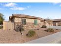 Side view of a house with stone and stucco exterior, and landscaping at 5758 W Kowalsky Ln, Laveen, AZ 85339