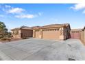 Three-car garage and front yard view of a single-story house at 5758 W Kowalsky Ln, Laveen, AZ 85339