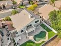 Aerial view showcasing a two-story house, pool, and surrounding landscape at 6270 W Rose Garden Ln, Glendale, AZ 85308