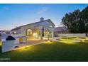 Expansive backyard with a pool, artificial turf, and outdoor kitchen at 6270 W Rose Garden Ln, Glendale, AZ 85308