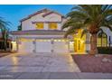 Two-story house with three-car garage, palm tree, and well-manicured landscaping at 6270 W Rose Garden Ln, Glendale, AZ 85308