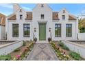 Stunning white brick home with a green door, landscaped walkway, and flowerbeds at 6737 E Exeter Blvd, Scottsdale, AZ 85251