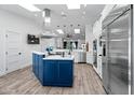 Bright kitchen with stainless steel appliances and blue island at 7480 E Sweetwater Ave, Scottsdale, AZ 85260