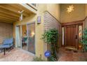 Inviting entryway with a wooden door, tiled flooring, and a view into the living area at 7846 E Mackenzie Dr, Scottsdale, AZ 85251