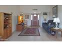 Bright and spacious living room with tiled floors and comfy seating at 9346 W Glen Oaks N Cir, Sun City, AZ 85351