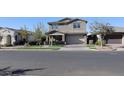 Beautifully landscaped home with a covered porch and a two-car garage, nestled in a quiet neighborhood at 9750 E Radioactive Dr, Mesa, AZ 85212