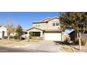 Two-story house with tan siding, attached garage, and front yard at 9750 E Radioactive Dr, Mesa, AZ 85212