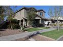 Charming stucco home with a covered front porch and mature landscaping in a desirable neighborhood setting at 9750 E Radioactive Dr, Mesa, AZ 85212