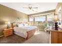 Bright main bedroom with a king-size bed and large windows at 9945 E Prospector Dr, Gold Canyon, AZ 85118