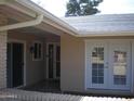 House exterior showcasing entryway with double doors and sliding glass door at 10731 W Mission Ln, Sun City, AZ 85351