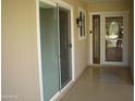 Inviting front porch with decorative glass door, window, and sliding glass door for easy indoor/outdoor living at 10731 W Mission Ln, Sun City, AZ 85351