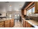 Kitchen with granite countertops, stainless appliances, bar and barstool seating, and backyard access at 11346 E Renata Ave, Mesa, AZ 85212