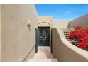 Elegant entryway with a wrought-iron gate and double doors at 15234 E Sundown Dr, Fountain Hills, AZ 85268